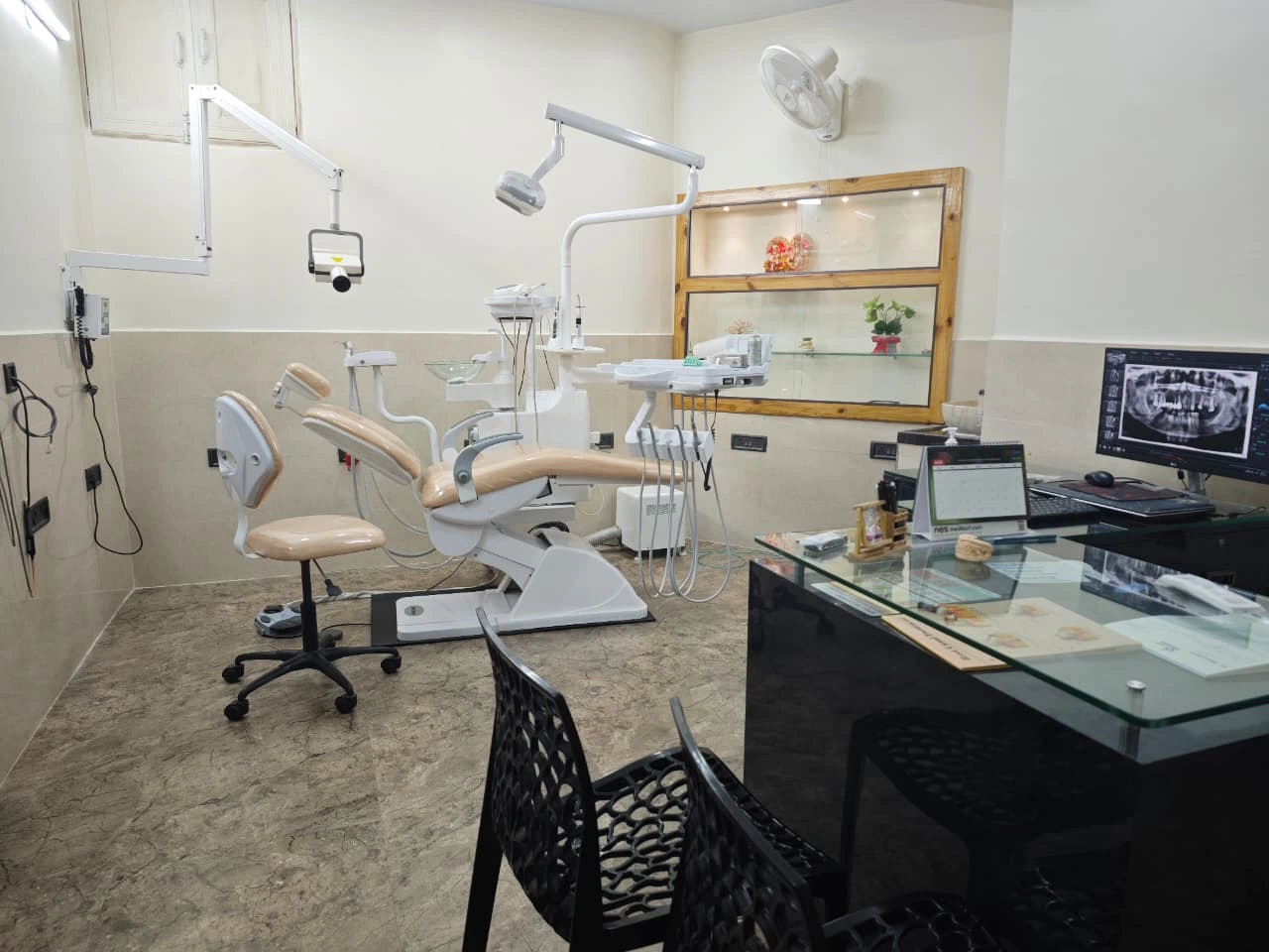 Dental chair, doctor table, monitor and black visitor chairs at Dr. Dent Dental Clinic
